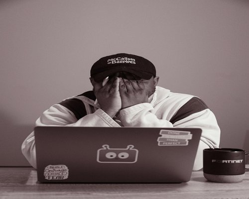 Tired person working on laptop